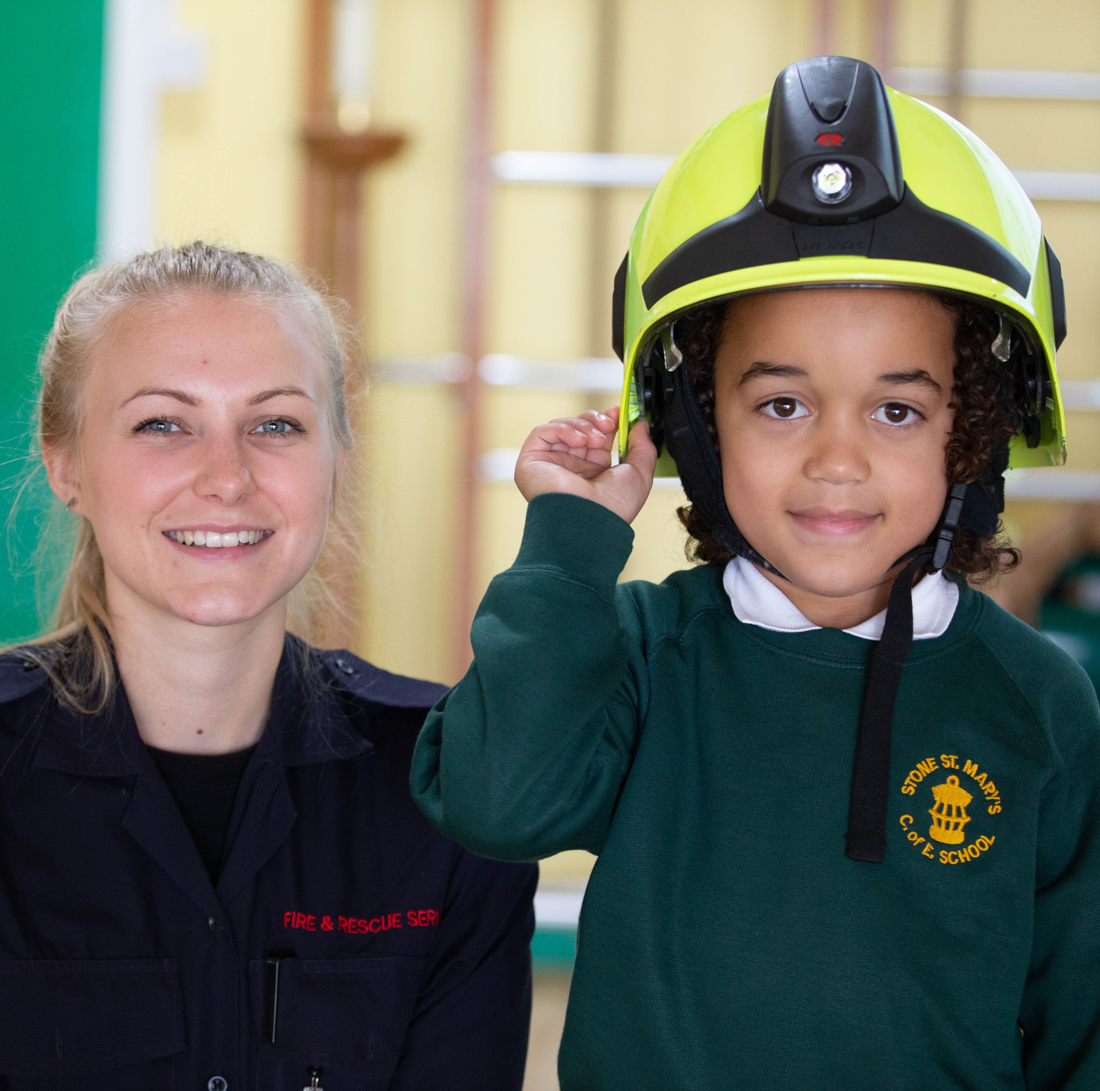 Firefighter posing with school kid