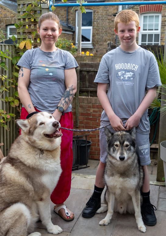 Nick with his mum Louise and their two dogs. 