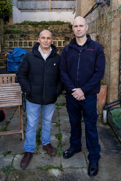 Said and Iain stood outside his house that was destroyed by fire