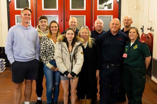 Grace Yates with her mum, the Malone family and emergency services