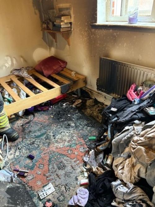 A bedroom with heat and smoke damage caused by an electrical fire.