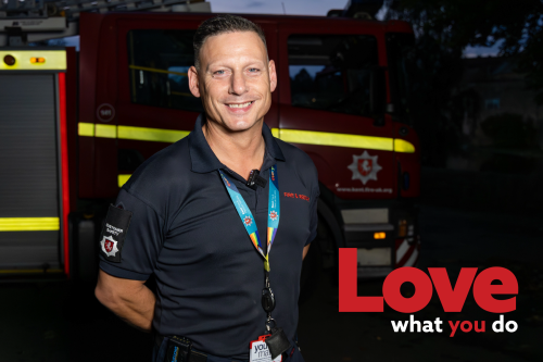 Image of on-call firefighter Robbie in front of a fire engine