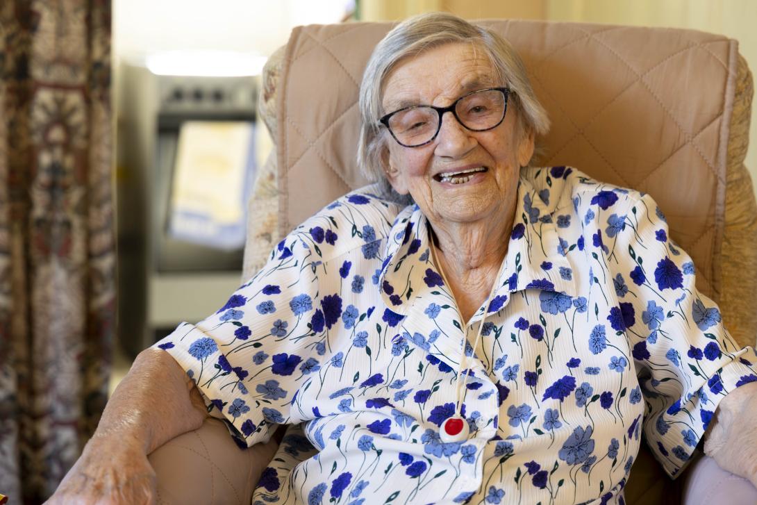 110 year-old Hilda, sat on an armchair, during a home Fire and Safety Visit