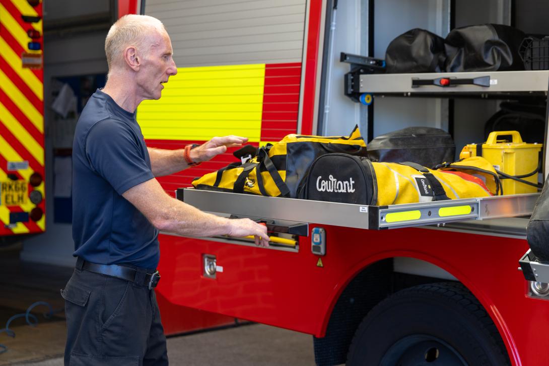The equipment storage space is demonstrated on the new vehicle.