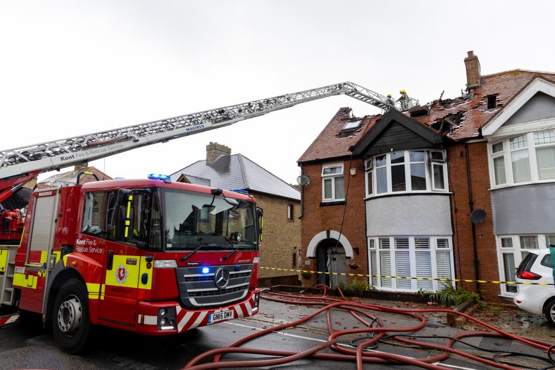 KFRS crews tackling a fire in the exposed roof of a house, using a heigh vehicle