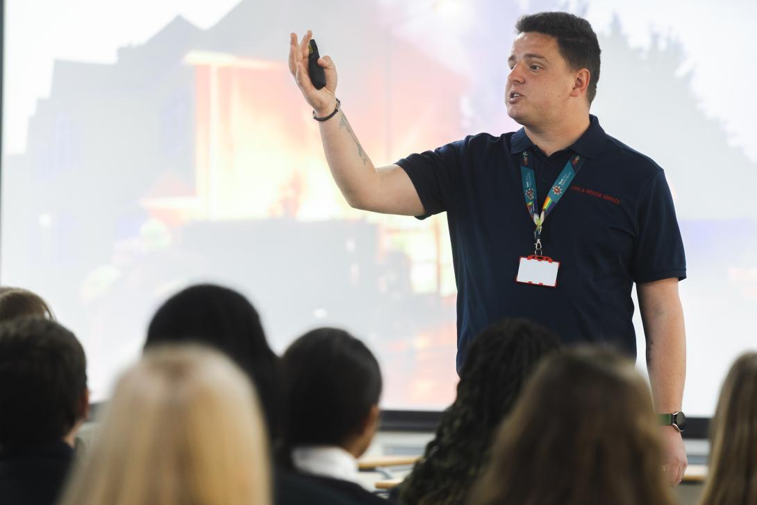 education officer teaching secondary school children about fire safety