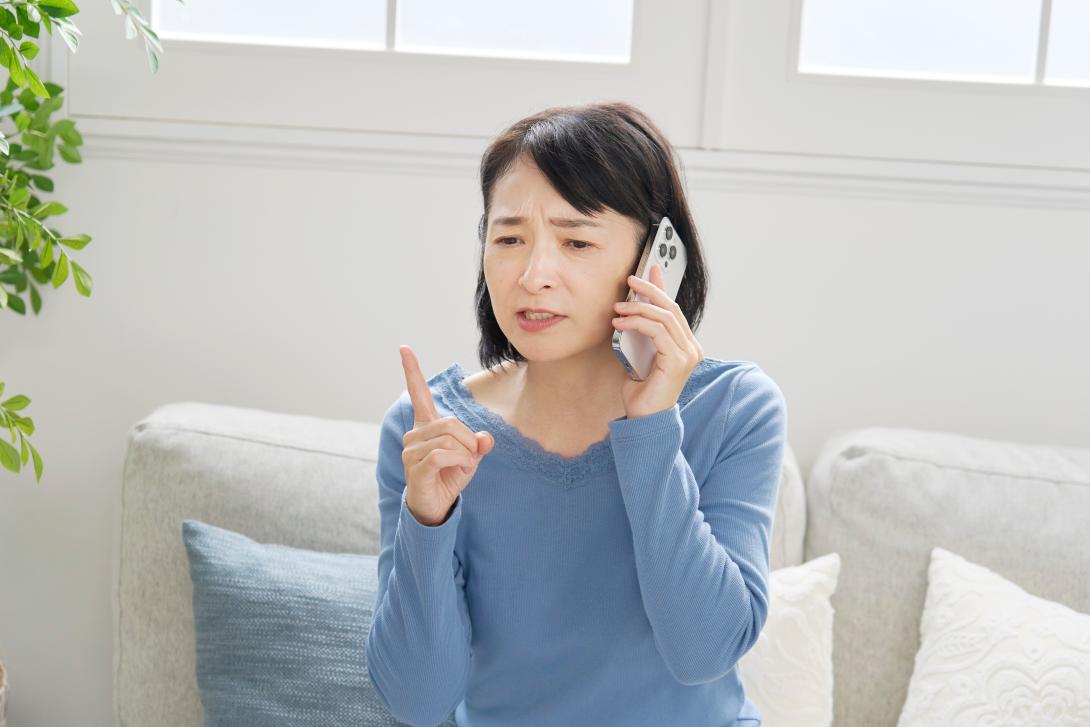 Woman looking worried and holding phone