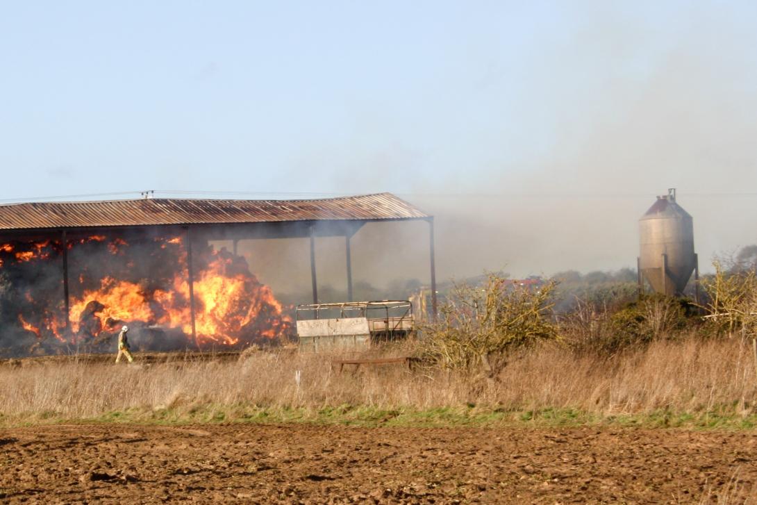 hay burning in a barn on a farm