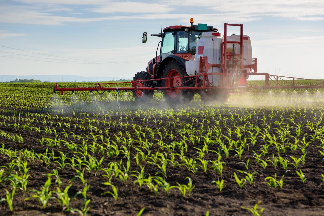 Tractor spraying crops
