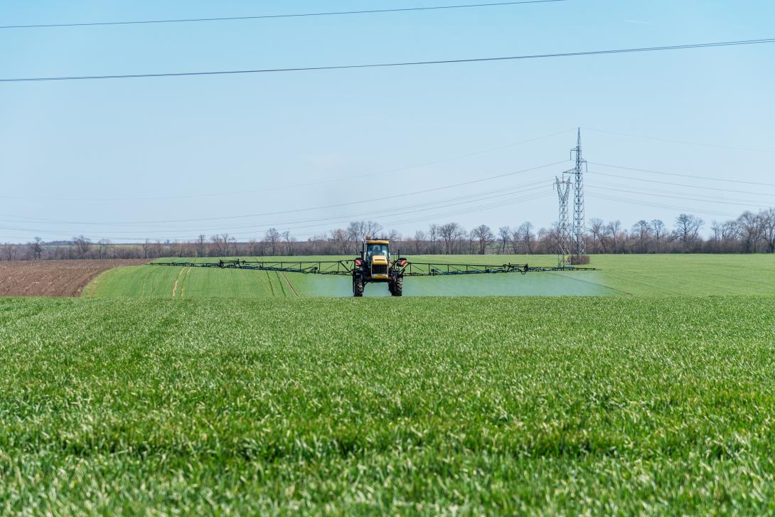 Tractor spraying under overhead power lines