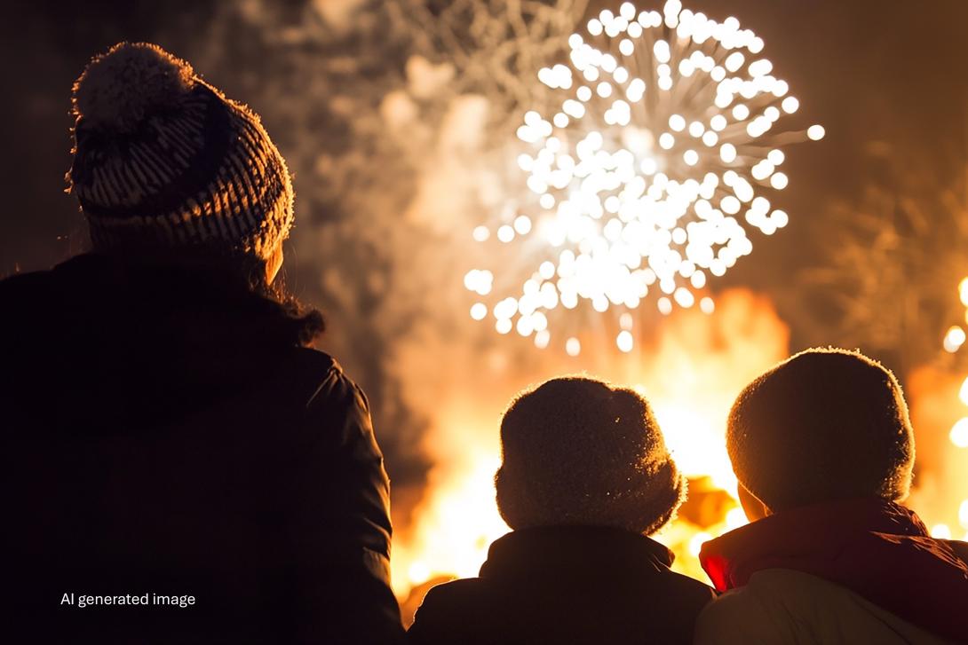 family watching fireworks and bonfire