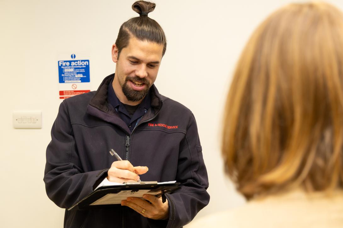 A KFRS building safety inspector giving advice.