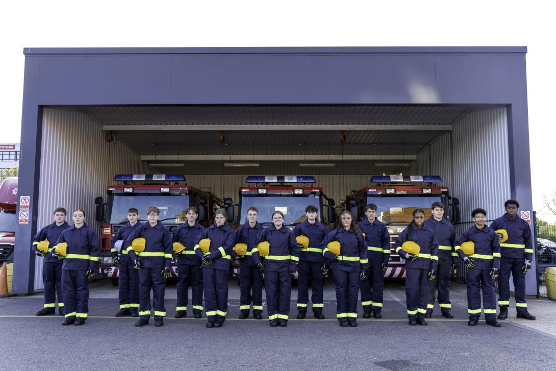 Fire cadets lined up in front of fire engines