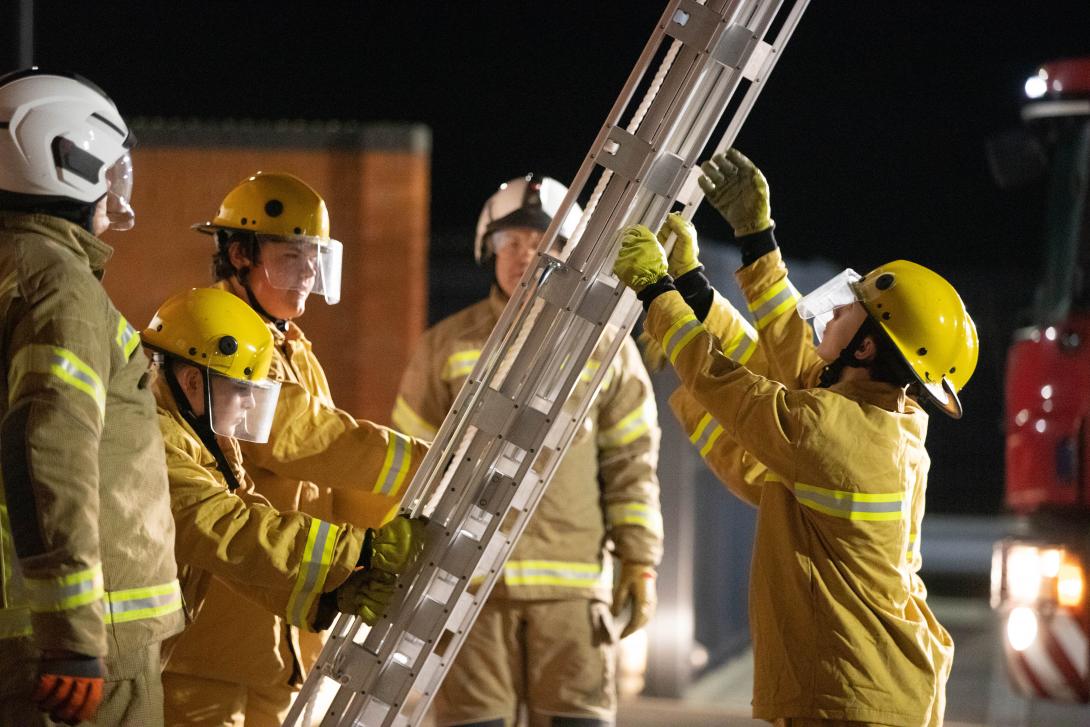 Cadets lifting up a ladder