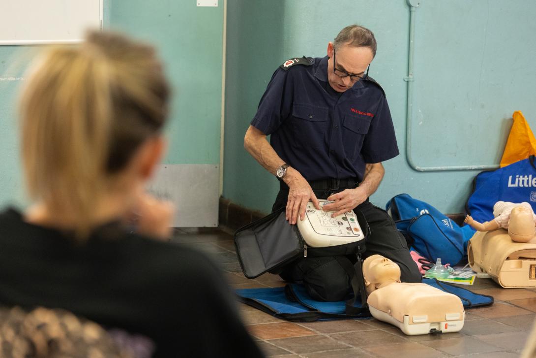 KFRS colleague demonstrating how to use a defibrillator