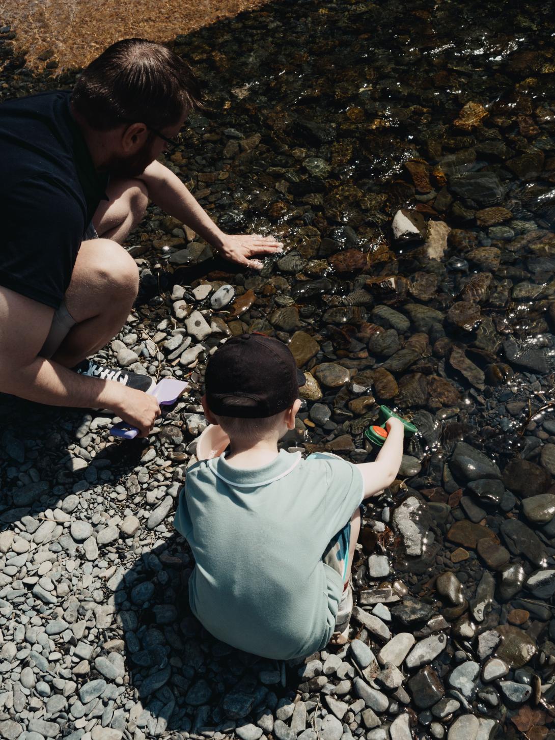adult and child playing in water