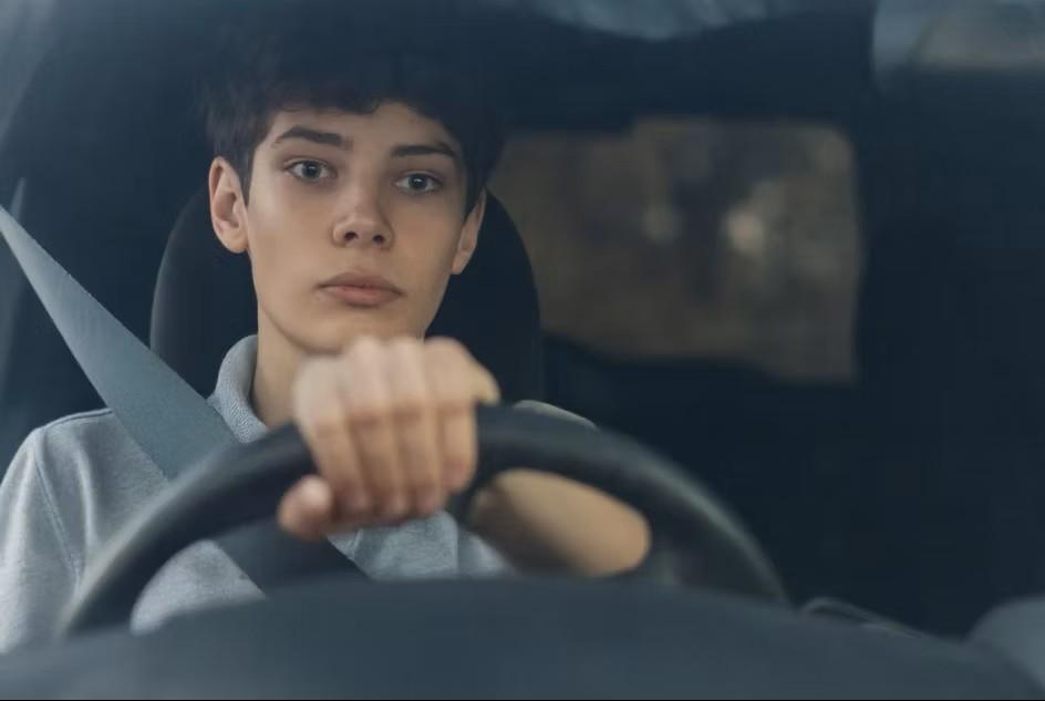 Young person driving a car
